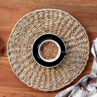 Natural seagrass placemat for dining, featuring a textured and eco-friendly design.