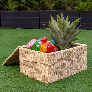 Handwoven seagrass picnic basket with a natural, rustic design.