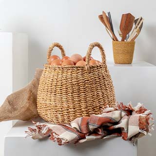 Handwoven seagrass egg basket with a natural, decorative design.